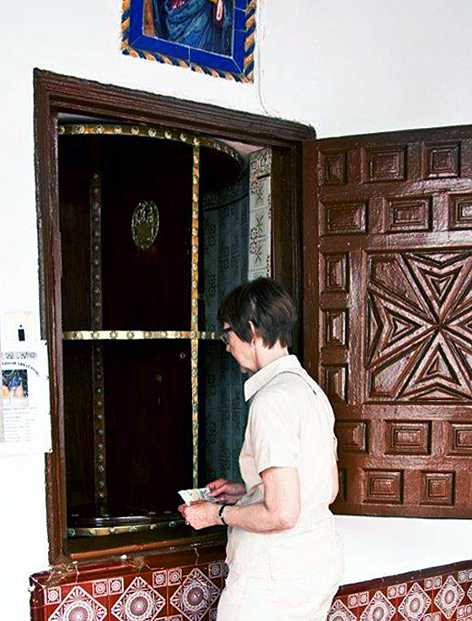 Woman buying sweets from San Leandro convent in Sevilla, Spain
