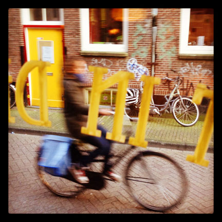 Man on bike through window in Amsterdam