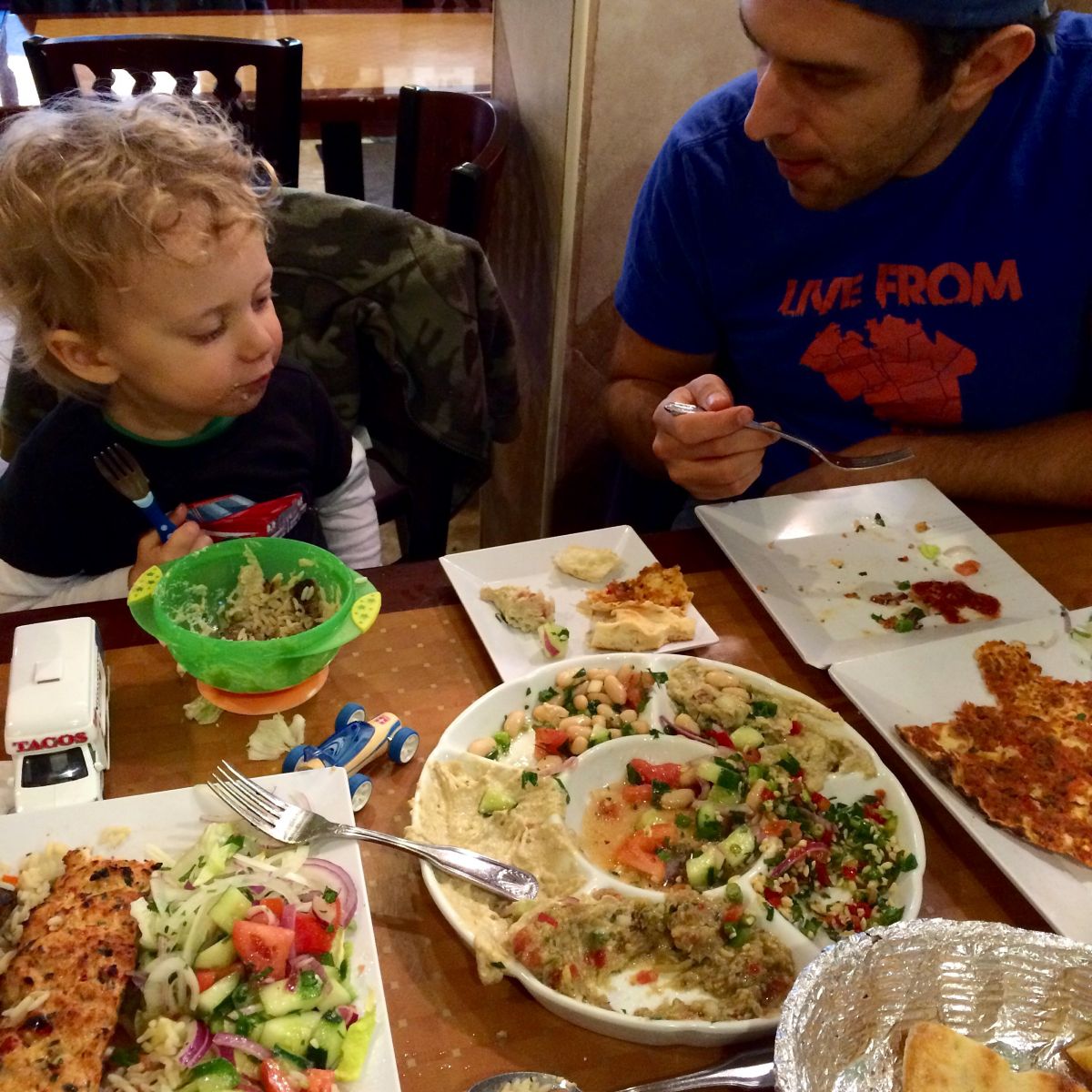 Toddler and dad eating Turkish food at a restaurant