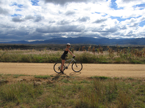 Woman bikes near Monte Alban, Oaxaca, Mexico