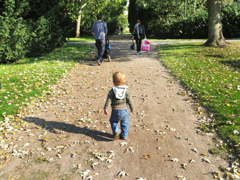 Toddler walking through Kungsparken (King's Park) in Malmo, Sweden