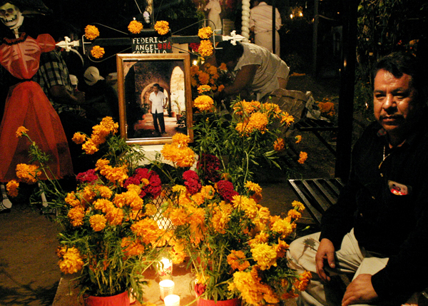 Man at a family grave for the Day of the Dead, Oaxaca