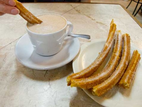 Churros dipped in hot chocolate.