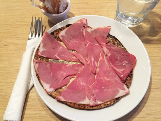 A plate of hangikjot, or smoked lamb, over rye bread in Iceland