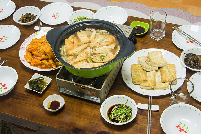 Rice cakes, fish cakes, anchovies and more for dinner in a Korean home.