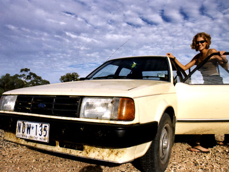 Female and a car, on a road trip