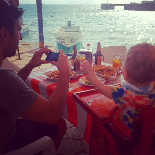 Taking photos of ceviche with a baby on Isla Mujeres, Mexico