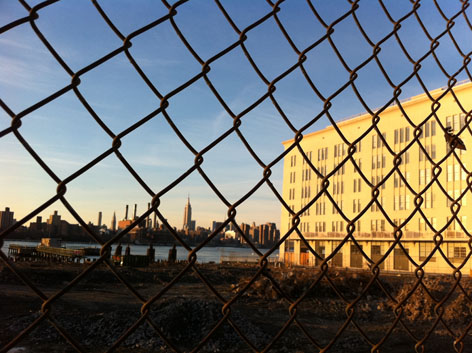 View of the NYC skyline through a fence, from Williamsburg, Brooklyn
