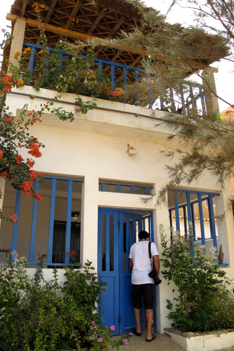 Man enters a beachfront apartment in Popenguine, Senegal
