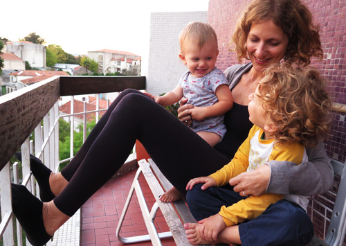 Two kids and mom on a terrace in Portugal, Europe