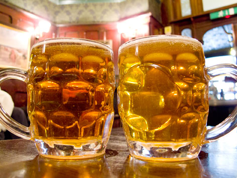 Two mugs of real ale from a London pub, in England