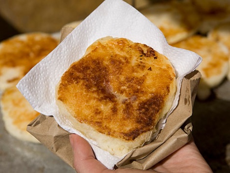 A delicious arepa con queso on the street in Cartagena, Colombia.