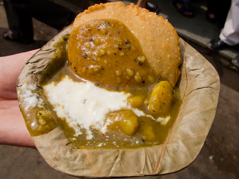 Bedai and jalebi in a paper cup from Deviram in Agra, India.