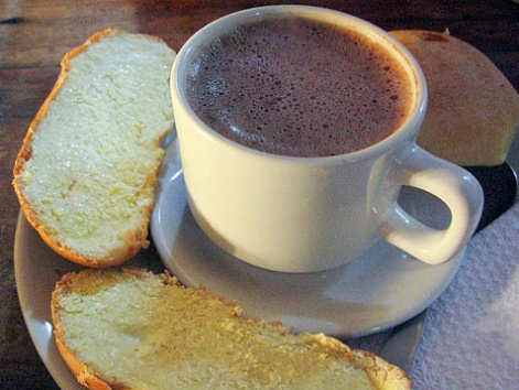 A mug of chocolate santafereño with toast from La Puerta Falsa in Bogota, Colombia. 