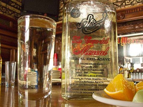 A bottle of Mezcal and shot glass from La Casa del Mezcal in Oaxaca, Mexico.