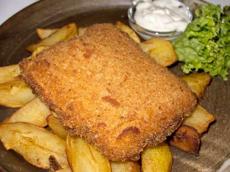 A plate of smažený sýr, or fried cheese, over fries in Prague, Czech Republic