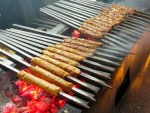 Mutton burra grilling over charcoal from Karim Hotel in Delhi, India. 