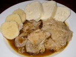 A plate of vepro-knedlo-zelo, roast pork with cabbage and bread dumplings, in Prague, Czech Republic